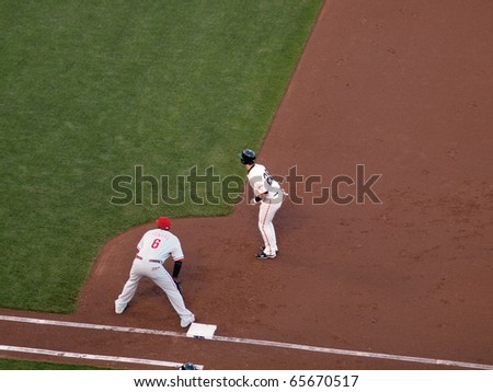 SAN FRANCISCO, CA - OCTOBER 20: Giants vs. Phillies: Buster Posey takes lead from first with Ryan Howard standing on the base game four of the NLCS 2010 October 20, 2010 AT&T Park San Francisco.