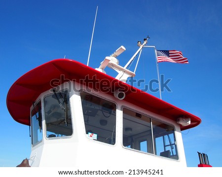 PORTLAND, MAINE - JUNE 2: Casco Bay Ferry Boat Cockpit with Coast Guard sticker and USA Flag flying overhead in Portland, Maine, June 2, 2014