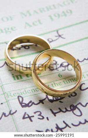 stock photo Pair Of Gold Wedding Rings On Marriage Certificate