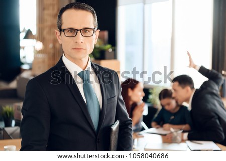 Serious adult man in suit stands in front of office of family lawyer. Lawyer for family affairs and divorce. Family in office of family lawyer.