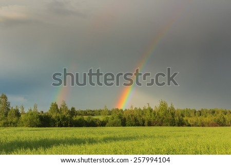 Double rainbow in sky after summer rain