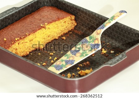 Orange yellow color pumpkin one layer cake without decorations in sheet pan with ceramic server