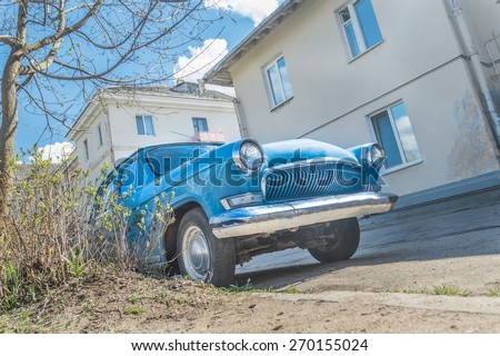 Season of spring fever for navy blue color old classic car in sunny back yard