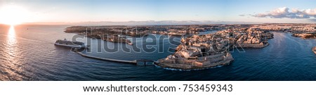 Aerial drone panorama sunrise photo- Cruise ship sailing into the Grand Harbour (harbor) of Valletta, Malta.  Island nation in the Mediterranean Sea, Europe.