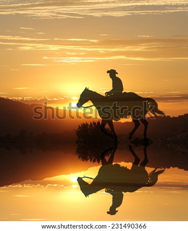 Artistic photography of a cowboy riding into the sunset with a mirror image of the horse and rider.