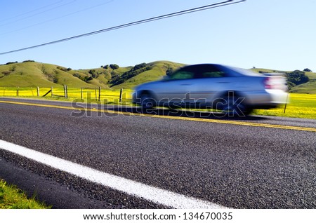 car moving quickly along a road from a low point of view
