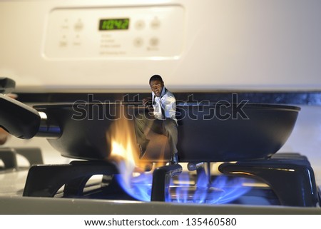 man jumping out of a frying pan and into the fire on a cooker