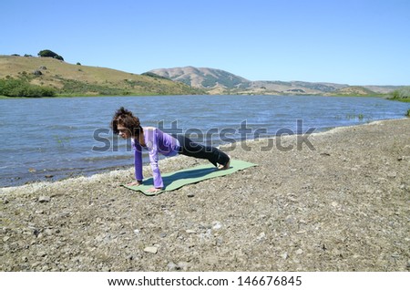 Woman holding a plank position outdoors