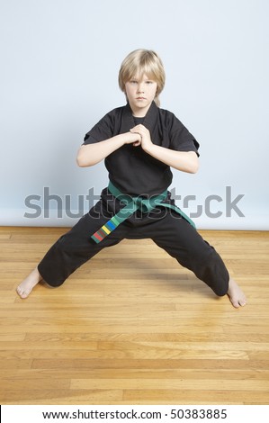 Young, male, green belt, Karate student greeting the room