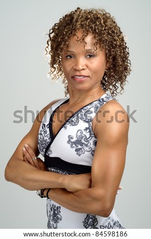 Upper body shot of a fit, toned woman wearing a halter neck sports top
