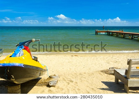 Tropical beach scene with personal water craft