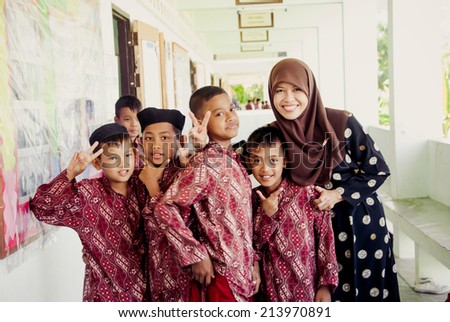 Yala, THAILAND - August 28, 2014. The group of Muslim : Women teacher and unidentified kids is smile and friendly in city Yala on August 28, 2014.Yala is the south of Thailand.