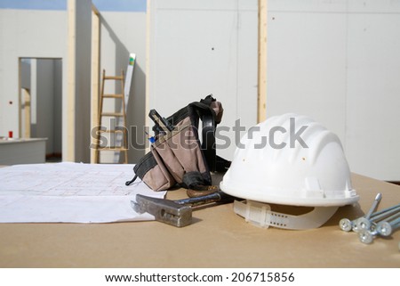 Building equipment and building plan: helmet, hammer, worker\'s tool bag, ladder