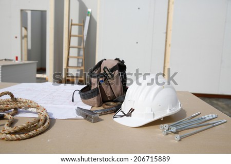 Building equipment, hardware and building plan: helmet, hammer, rope, screws,worker\'s tool bag