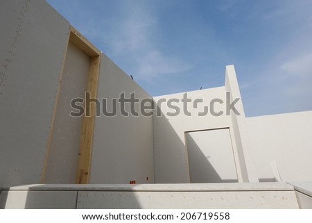 Prefabricated roofless house in the making with blue sky