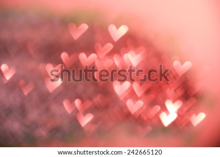 Red festive Valentine\'s day background. Abstract with bright heart-shaped twinkles, sparkles, blurred, defocused light.