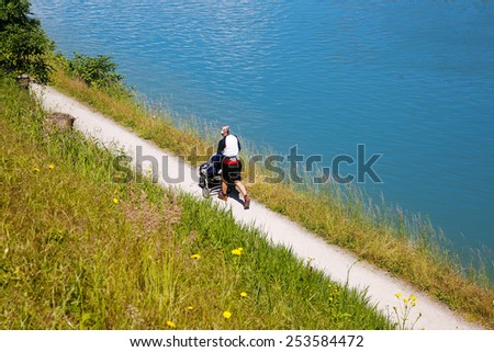 Active dad running, pushing a stroller and listening to music