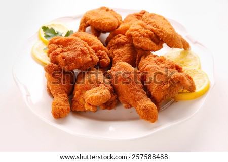 Deep fried chicken wings on a white plate