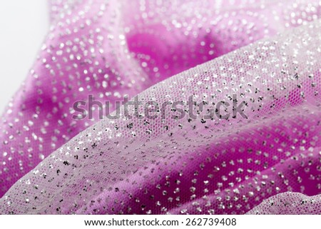 Fancy shiny glitter on a girly pink fabric, prepared for a dressing up, close-up