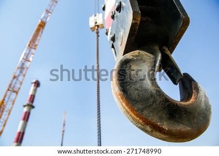 Hook of a mobile lifting crane on a construction site, capable of lifting 25 tons of load. Heavy duty machinery for heavy construction industry.