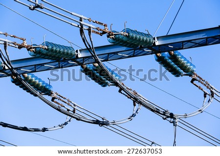 Specialist electrical ceramic insulators on wiring in a converter station, special type of transformer substation. Blue sky background, power, energy and electricity concept.