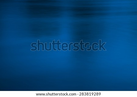 Deep and blurred, dark blue and black water surface, conceptual abstract background. Dark, sullen atmosphere, uneasiness, crime, fear, underground, and evil concept.