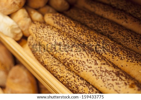 French Baguette/ Tasty french baguette arranged in rows on stand in bakery.