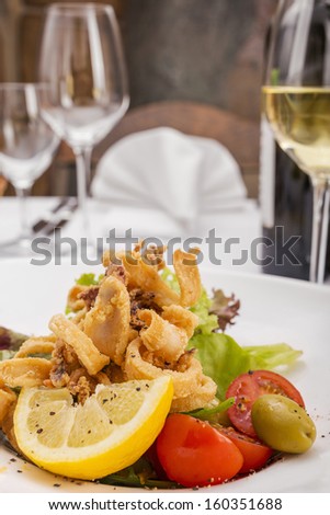 Seafood/Seafood. Delicious fried calamari ( Squid ), Served with olives, lemon, lettuce and tomato.