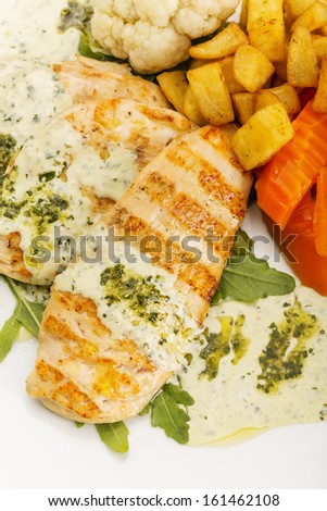 Dinner/A delicious chicken breast in white sauce. Served with steamed vegetables, carrots, cauliflower and potatoes.