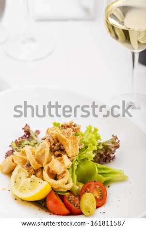 Seafood - Fried Calamari/Seafood. Delicious fried calamari ( Squid ), Served with olives, lemon, lettuce and tomato.