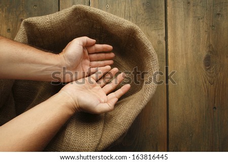Cupped hands and sackcloth texture/Cupped hands and wood table with jute coarse grain canvas texture ( seamless sackcloth ).