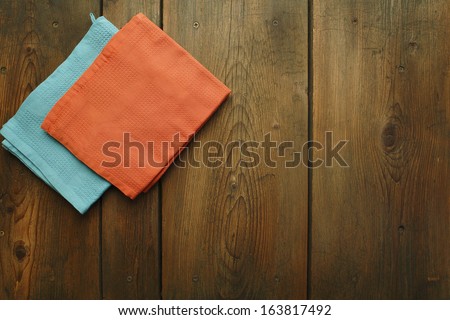 Kitchen table/Cookbook background. An old wooden kitchen table with kitchen dish cloth.