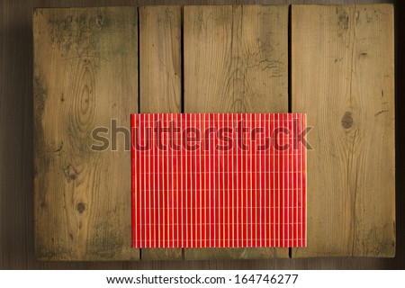 Picnic table/Cookbook background. Red mat on wooden picnic table.