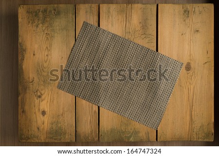 Picnic table/Cookbook background. Silver mat on wooden picnic table.