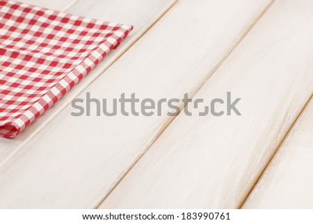 Plaid cloth on picnic table/Wooden picnic table background.