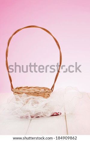 Elegant basket on picnic table/Basket on tulle and red plaid cloth on wooden table