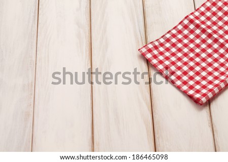 Plaid cloth on picnic table/Wooden picnic table background.