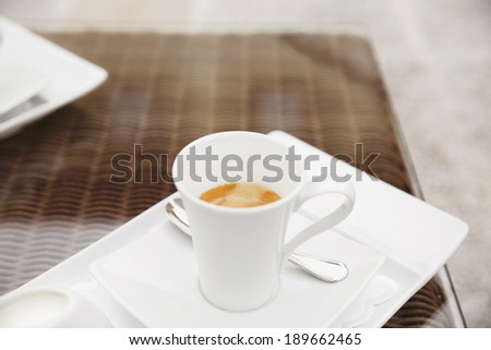 Espresso coffee serving in cafe/Decorative coffee set on glass coffee table.