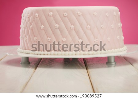 Cake/Decorative fondant pink cake on picnic table