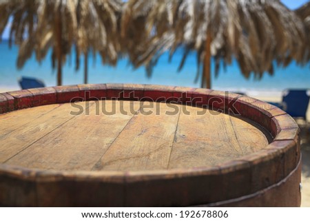 Wooden barrel on beach/Summer food background. Wooden background.