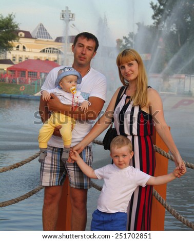 complete family picture on the background of the fountain in the summer