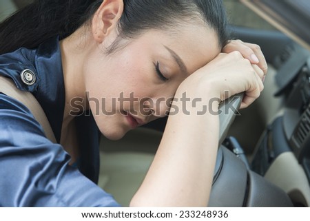 Asian women asleep while driving