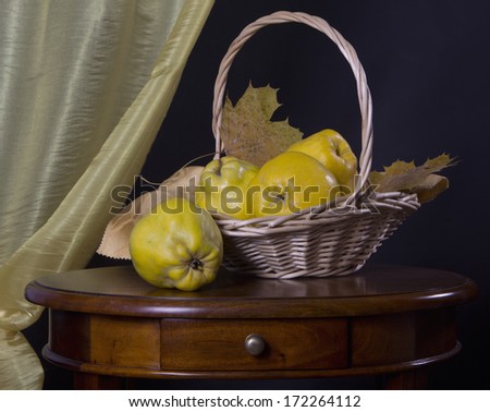 Classic still life with fruit in a basket on a black background