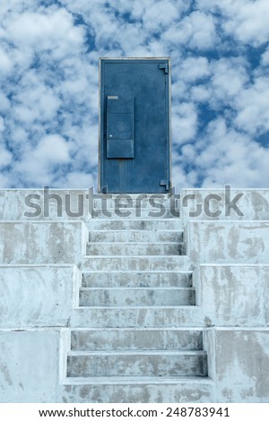 Concrete stair lead to the metal door on sky background.