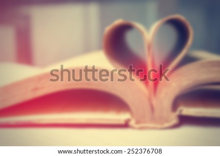 blurred book page heart.