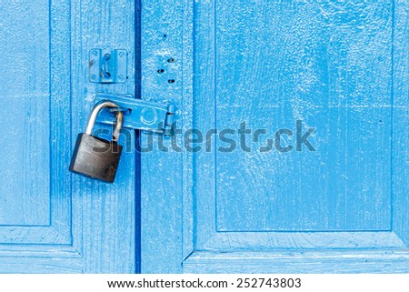 Key lock on blue wooden door.