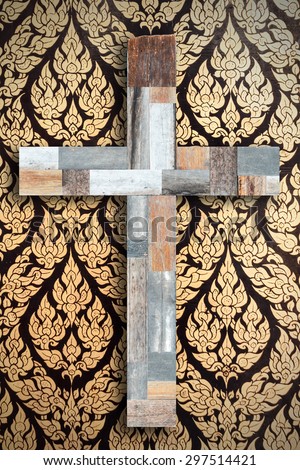 Wooden cross on  vintage traditional Thai mural art background.