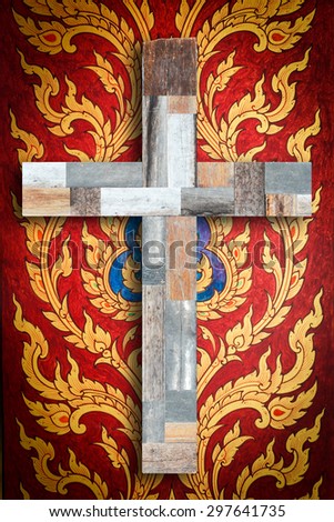 Wooden cross on  vintage traditional Thai mural art background.
