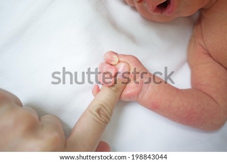 baby hand hold index finger