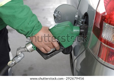 a duty refueling the car at a gas station